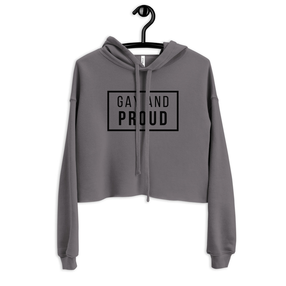 Front view of a gray cropped hoodie on a hanger reading “GAY AND PROUD”