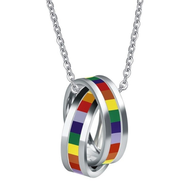 Silver chain necklace with two interlocking rainbow-striped rings on a white background