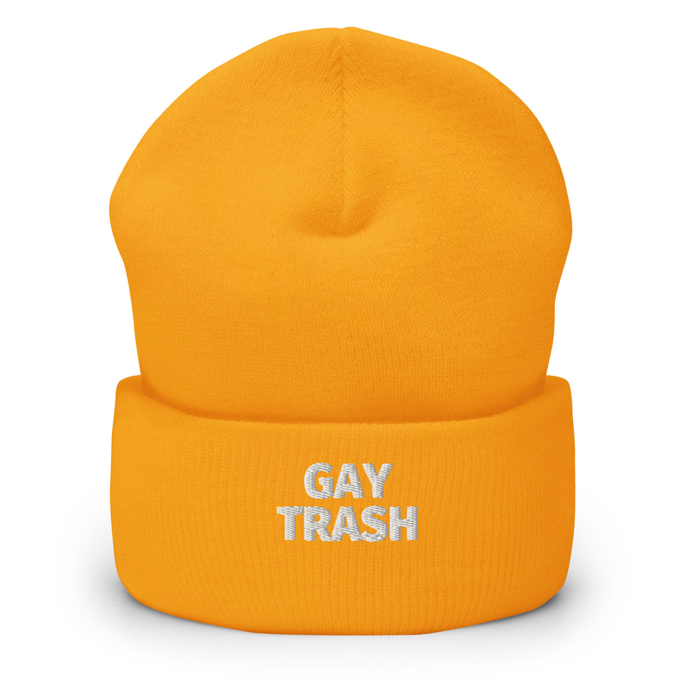 Front view of an orange cuffed beanie with silver “GAY TRASH” lettering