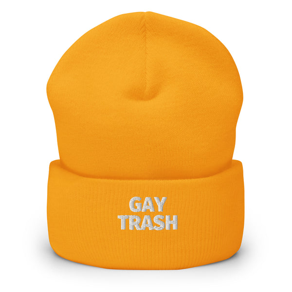 Front view of an orange cuffed beanie with silver “GAY TRASH” lettering