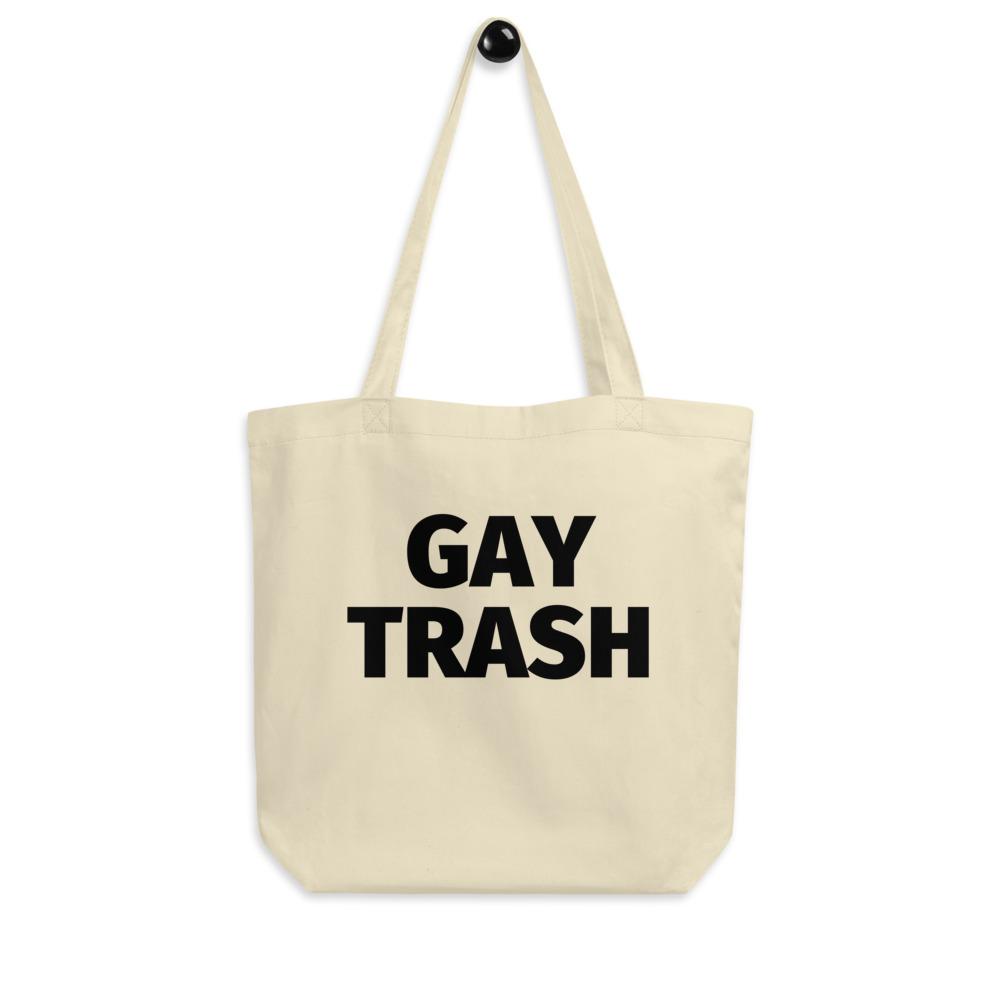 Cream canvas tote bag with bold black “GAY TRASH” text and long shoulder straps