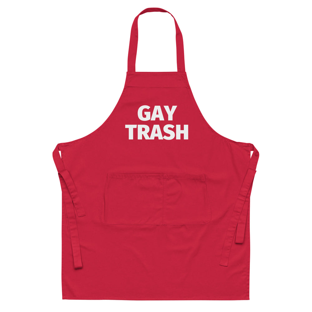 Front-facing red apron with white “GAY TRASH” lettering, neck loop, waist ties, and front pocket