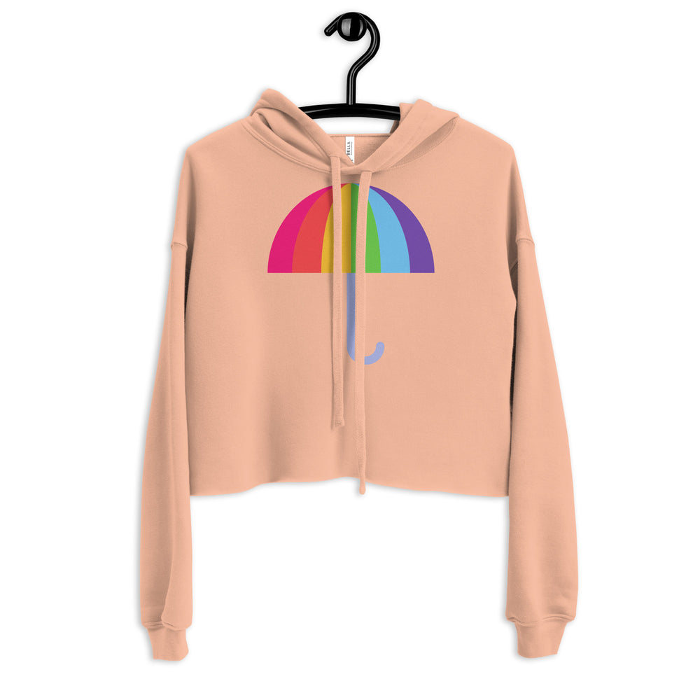 Front view of a peach cropped hoodie with a rainbow umbrella graphic and drawstrings