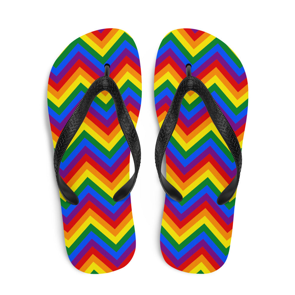 Pair of black-strap flip-flops with bright rainbow chevron-patterned footbeds