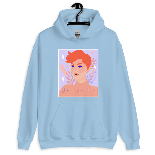 Light blue hoodie on a hanger with a red-haired portrait and “Gender is a construct tear it apart” text