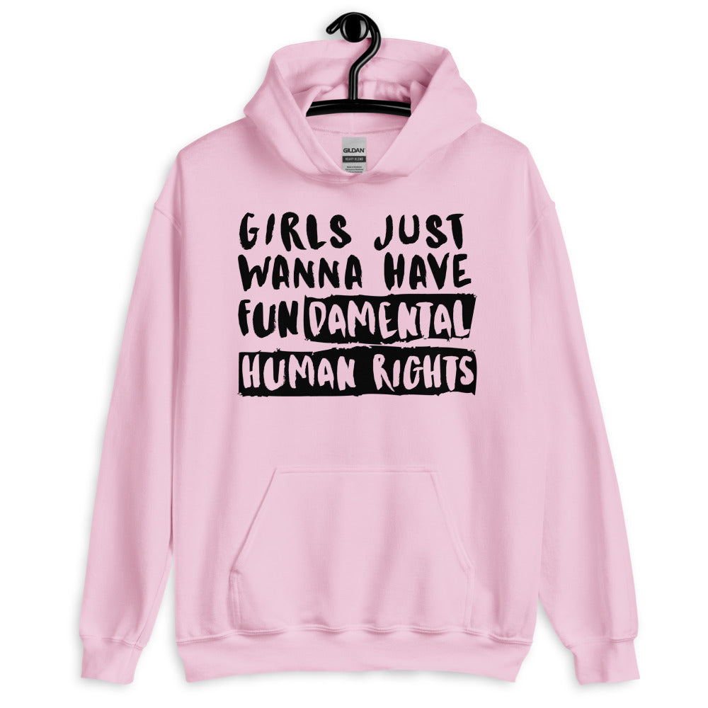 Front view of a light pink hoodie on a hanger reading “Girls Just Wanna Have Fundamental Human Rights.”