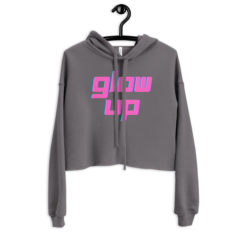 Front view of a gray cropped hoodie on a hanger with bright pink and turquoise “glow up” lettering