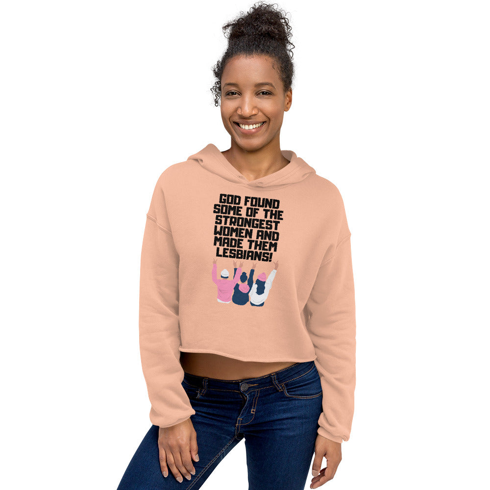 Model wearing a peach cropped hoodie reading “God found some of the strongest women and made them lesbians!”