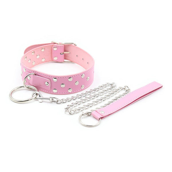 Pink studded collar with silver rings, chain lead, and matching strap on a white background