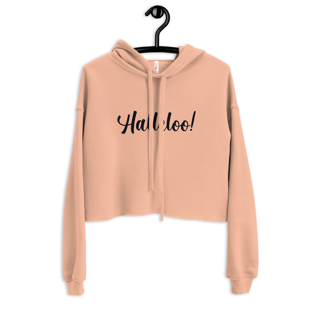 Front view of a peach cropped hoodie on a hanger with black “Halleloo!” lettering