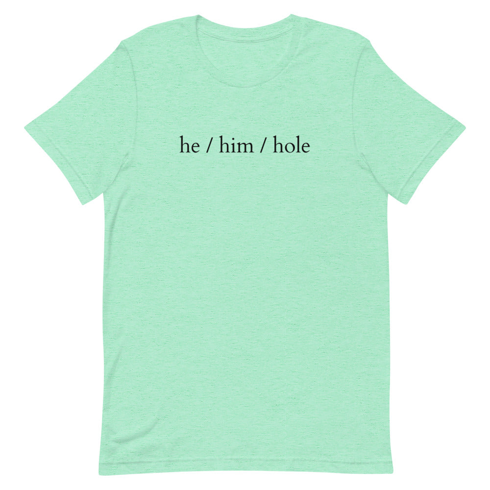 Flat-lay mint green T-shirt with black text reading “he / him / hole”