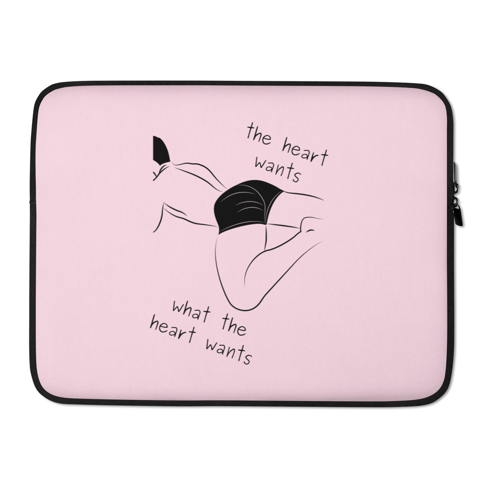 Pink laptop sleeve with black trim, reclining figure illustration, and “the heart wants what the heart wants” text