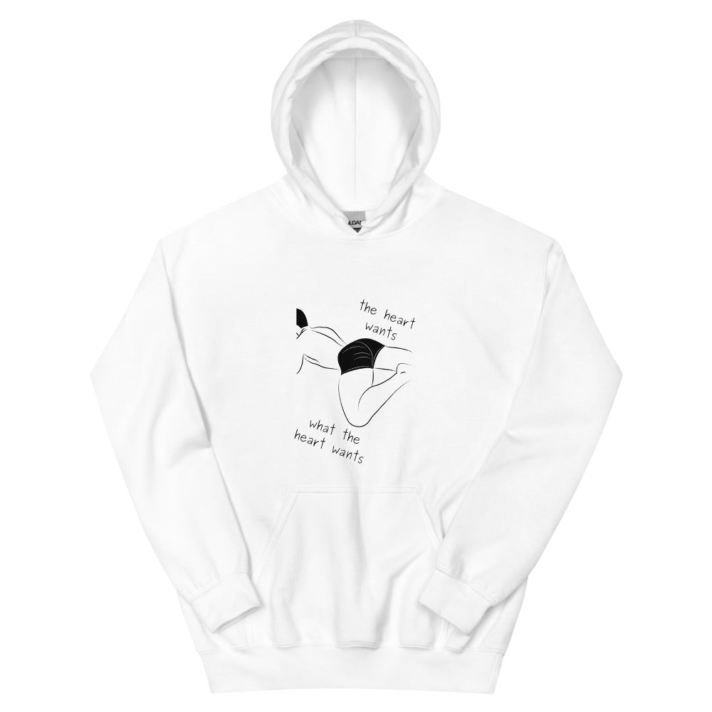 White hoodie with a black reclining figure and “the heart wants what the heart wants” text