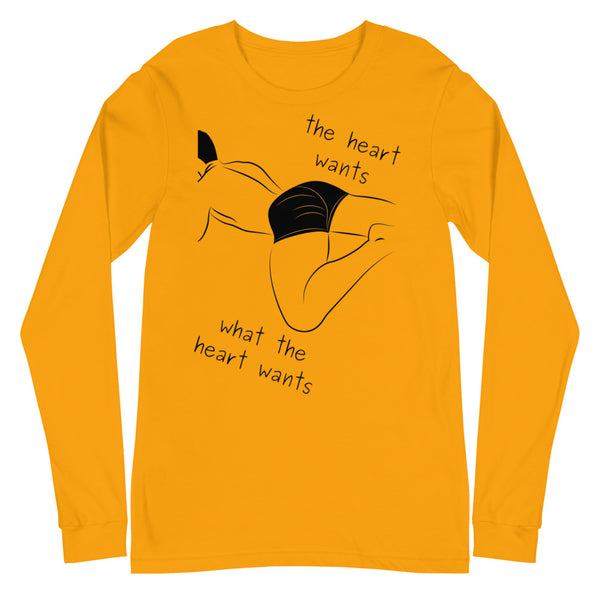 Front view of a mustard-yellow long-sleeve shirt with black line art and “The heart wants what the heart wants” text