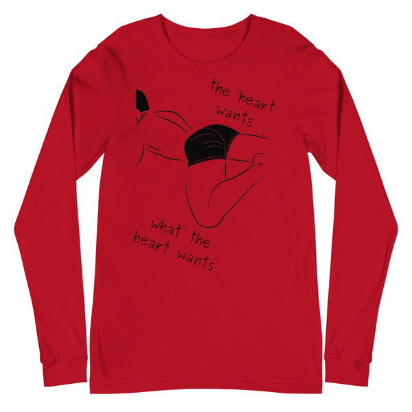 Front view of a red long-sleeve shirt with a black reclining figure and “the heart wants what the heart wants”