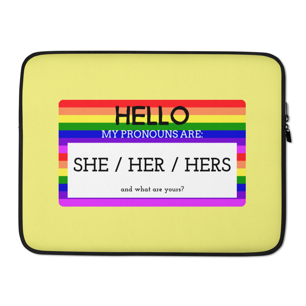 Yellow laptop sleeve with rainbow stripes and text, “Hello, my pronouns are: she / her / hers.”
