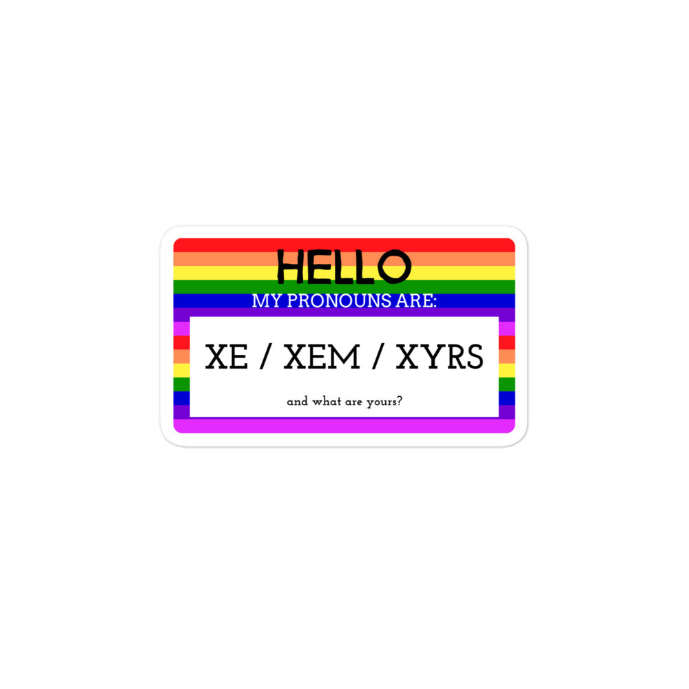 Rainbow-striped sticker reading “HELLO, MY PRONOUNS ARE: XE / XEM / XYRS”