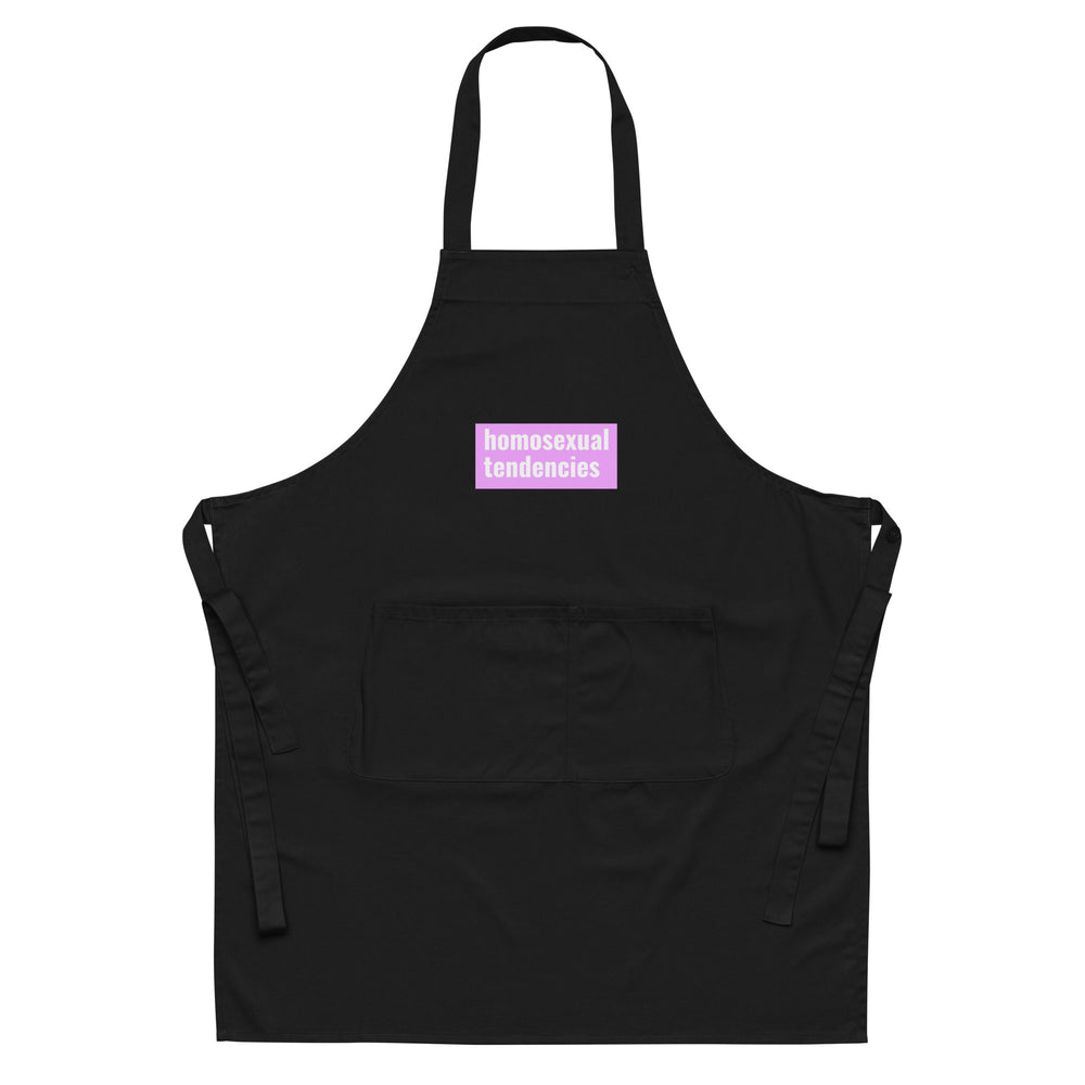 Front view of a black apron with a pink patch reading “homosexual tendencies” and a front pocket