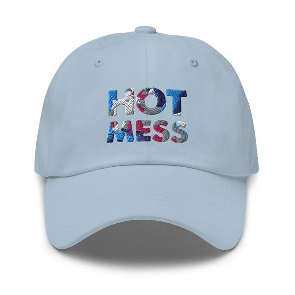 Front view of a light blue baseball cap embroidered with “HOT MESS” in multicolored thread