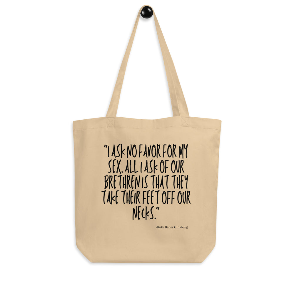 Front view of a beige tote bag printed with a quote about taking feet off necks.