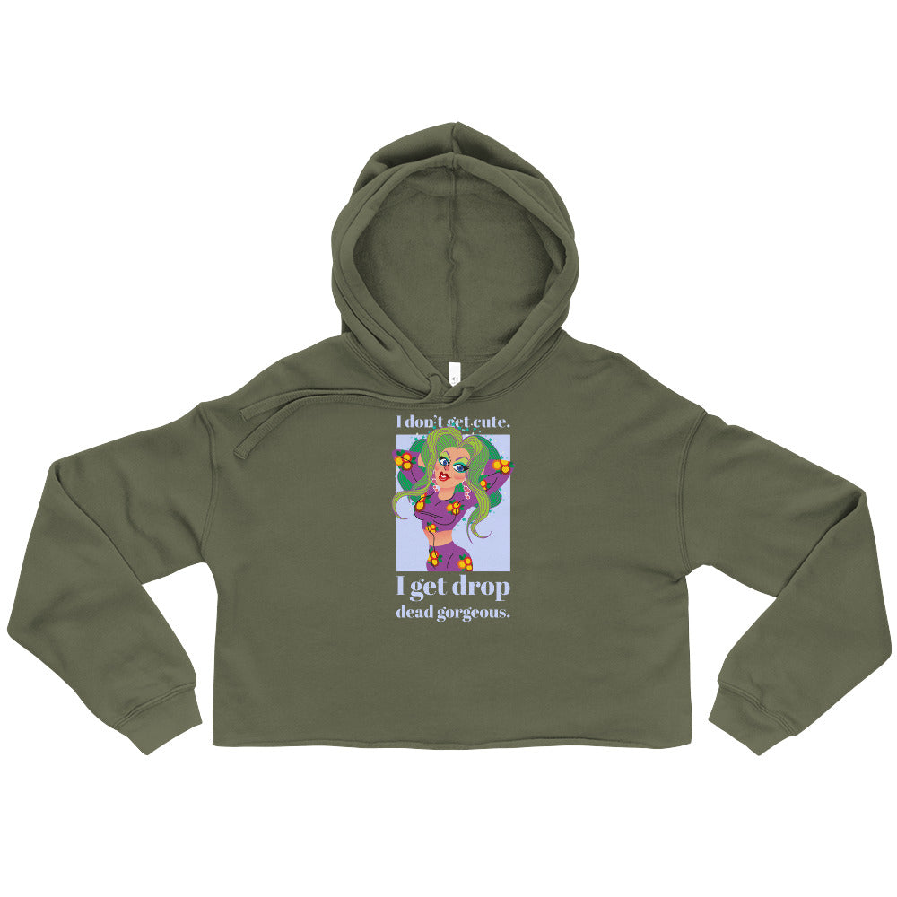 Military green cropped hoodie with a hood and colorful cartoon graphic reading “I don't get cute. I get drop dead gorgeous.”