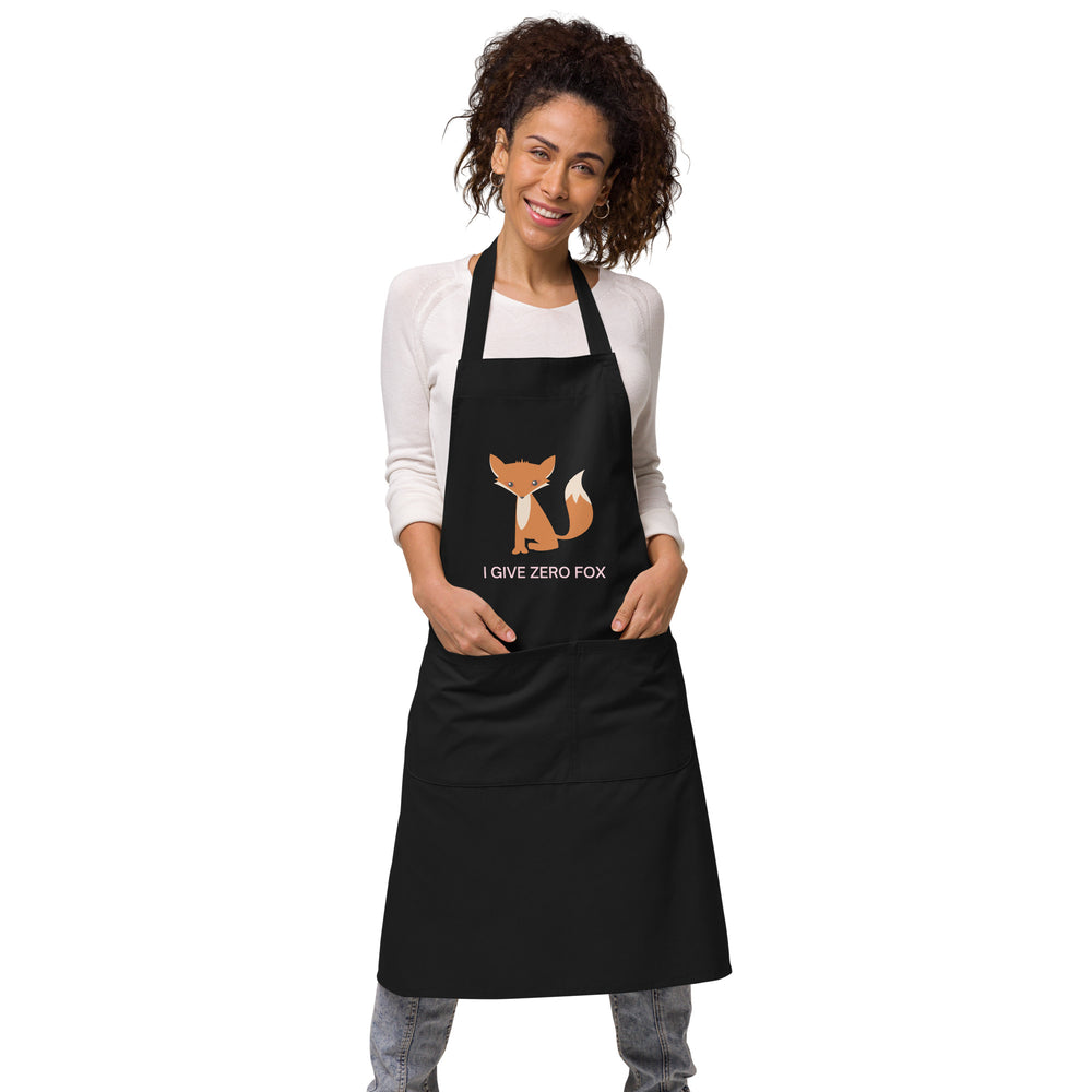 Front-view model wearing a black apron with a fox graphic and “I GIVE ZERO FOX” text