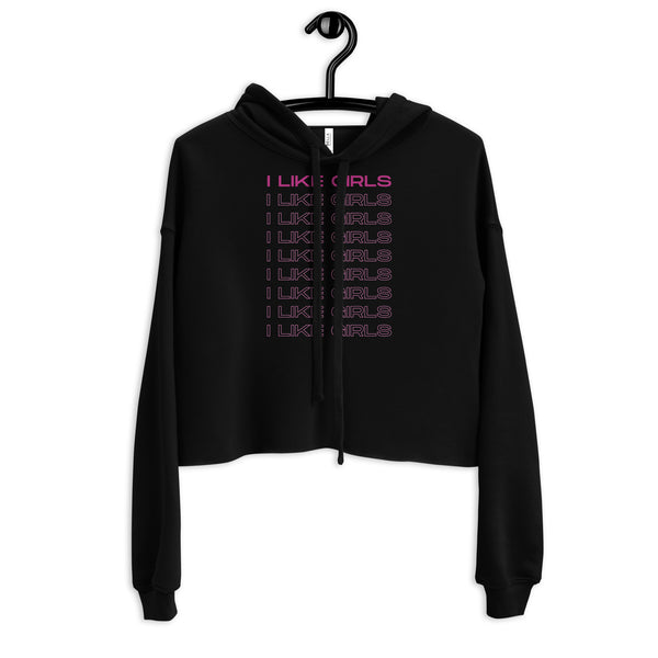 Front view of a black cropped hoodie on a hanger reading “I LIKE GIRLS” in pink repeated lines