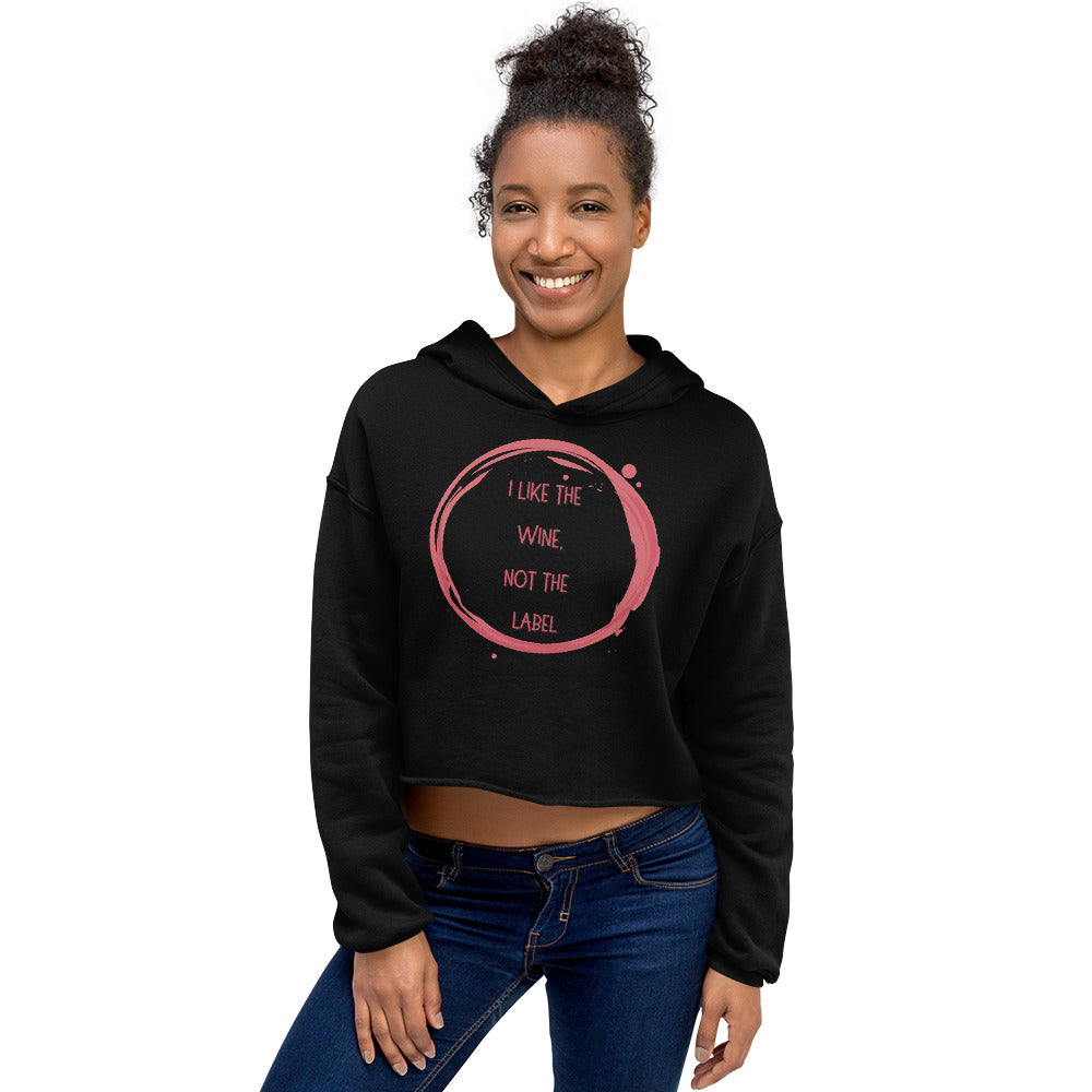 Model wearing a black cropped hoodie reading “I LIKE THE WINE, NOT THE LABEL”