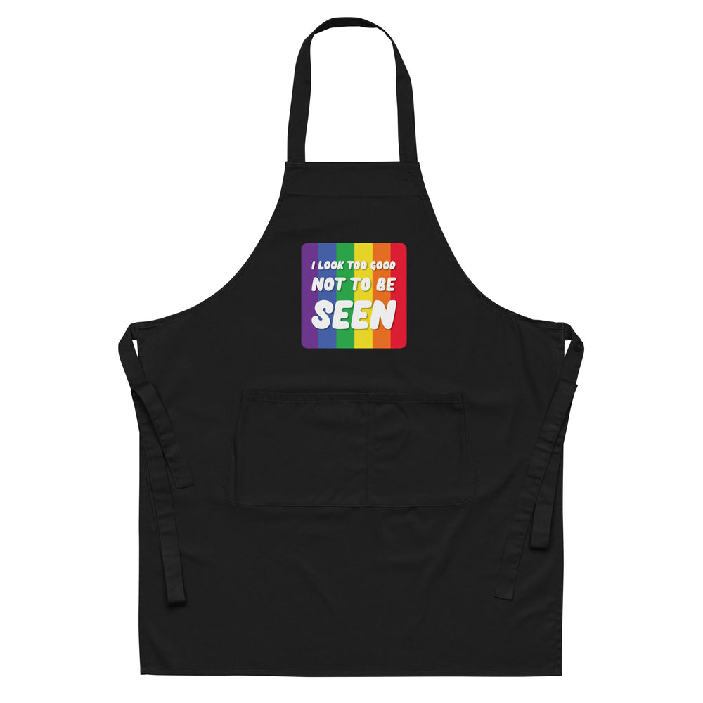 Front view of a black apron with rainbow stripes and “I LOOK TOO GOOD NOT TO BE SEEN” text