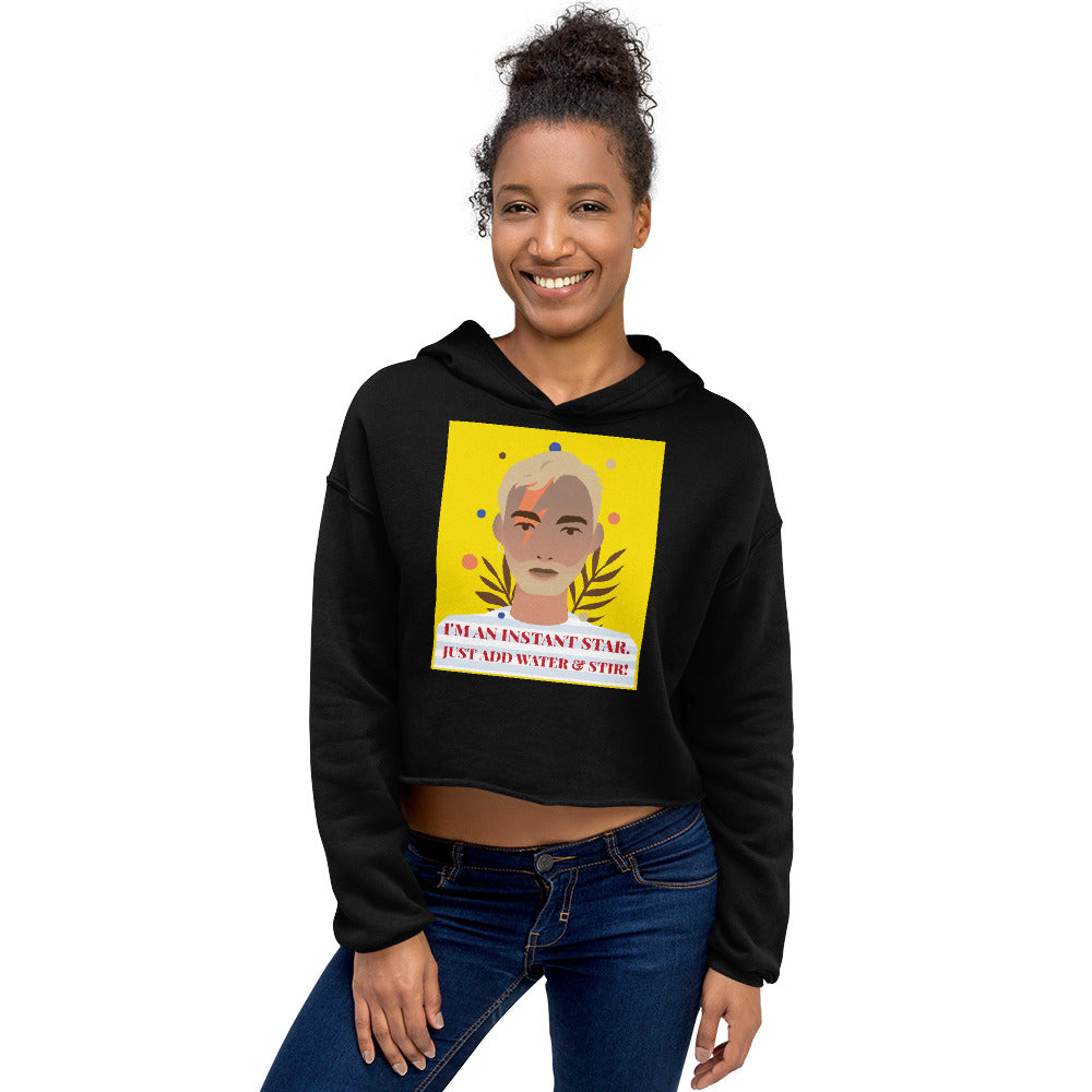 Model wearing a black cropped hoodie with a colorful portrait and “I'M AN INSTANT STAR” text