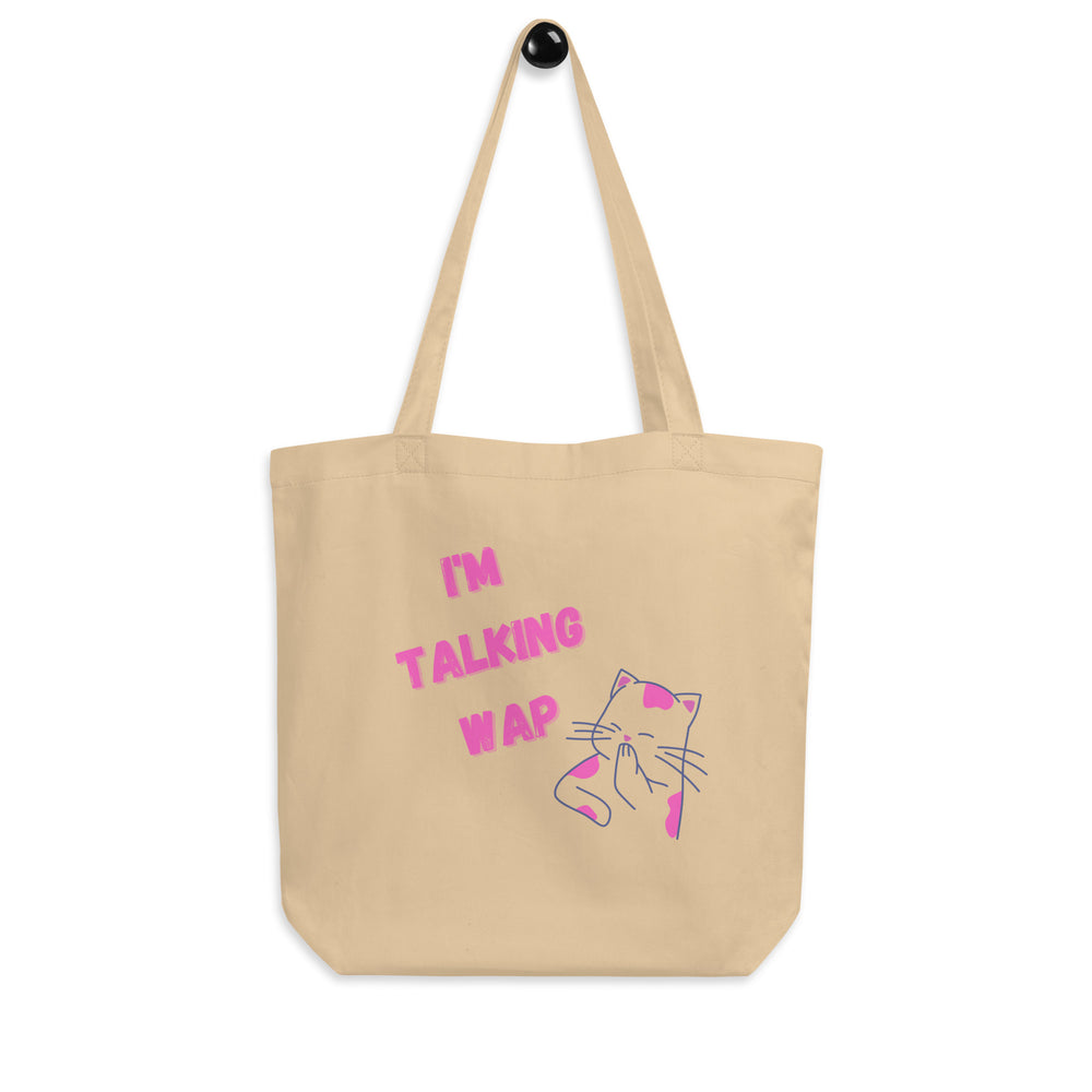 Front-view beige tote bag reading “I’M TALKING WAP” with a pink-and-blue cat illustration