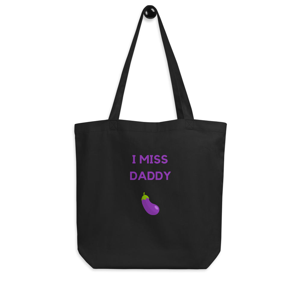 Black tote bag reading “I MISS DADDY” above a purple eggplant graphic