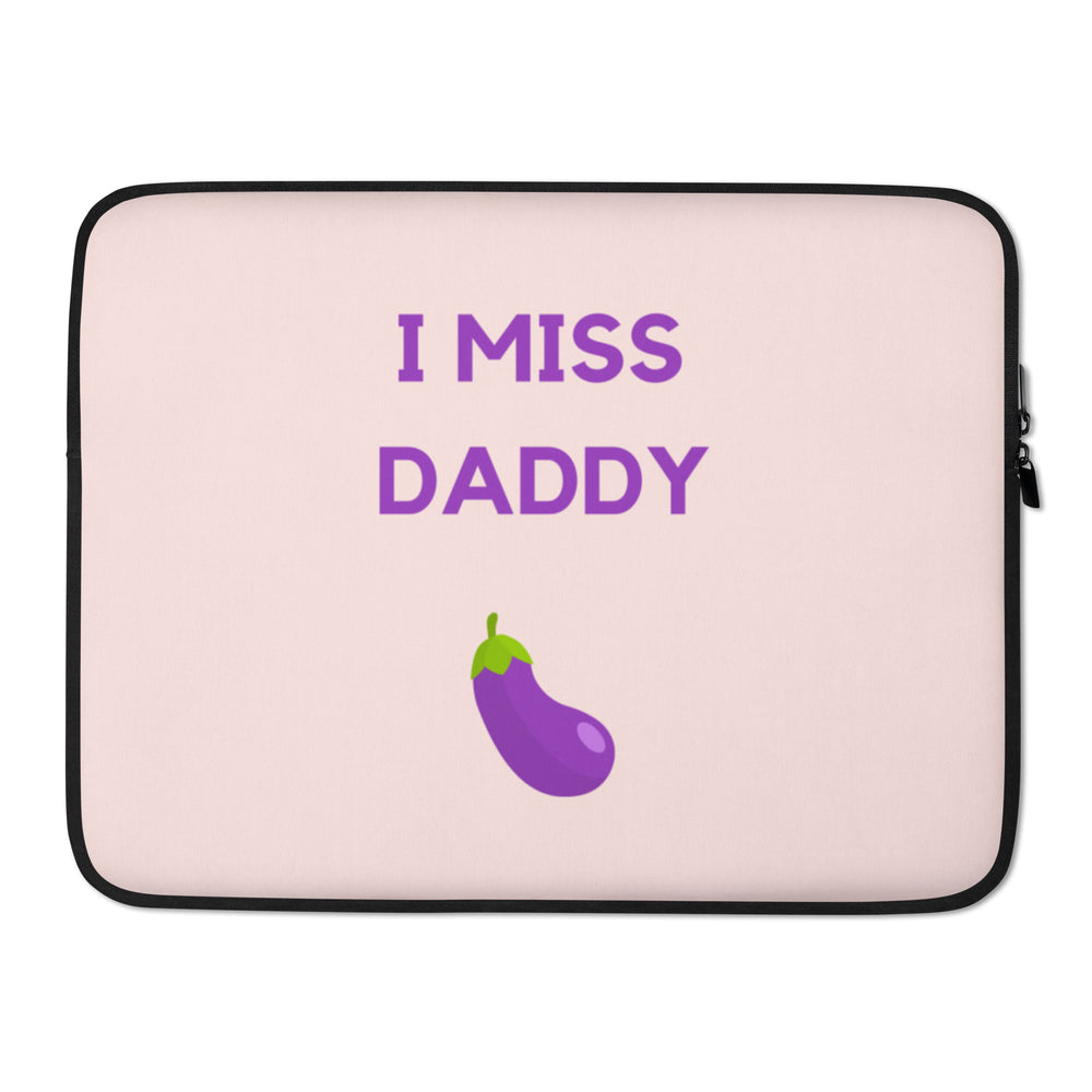 Front view of a pale pink laptop sleeve reading “I MISS DADDY” above a purple eggplant graphic
