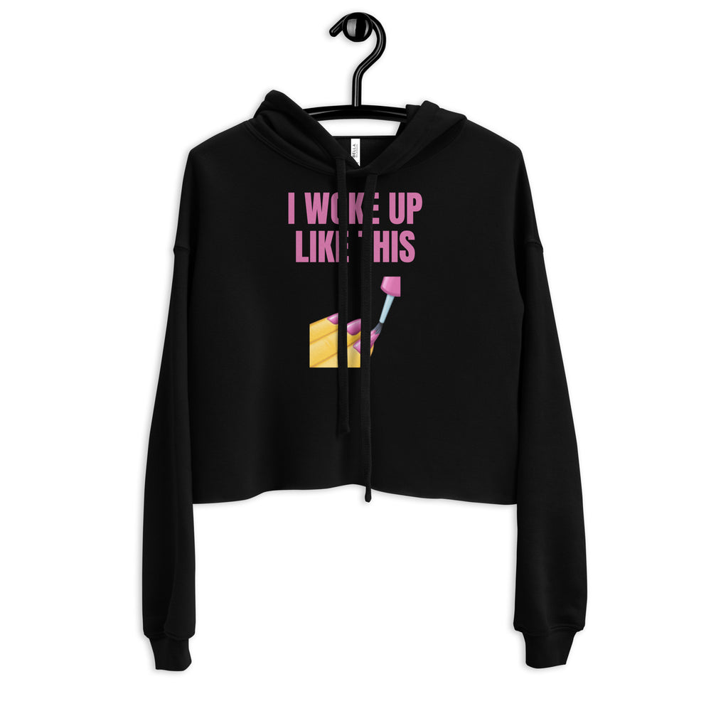 Front view of a black cropped hoodie with pink “I WOKE UP LIKE THIS” text and makeup graphic