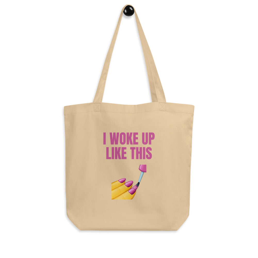 Oyster canvas tote bag reading “I WOKE UP LIKE THIS,” with a painted-nails makeup brush graphic