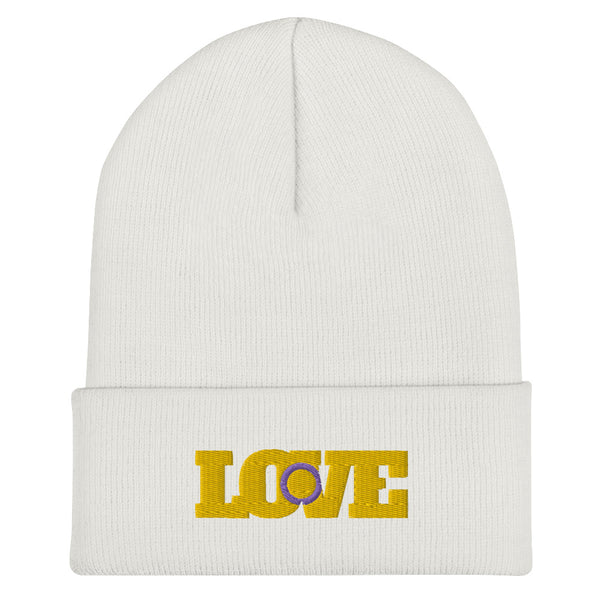 Front view of a white cuffed beanie with yellow LOVE lettering and a purple intersex symbol