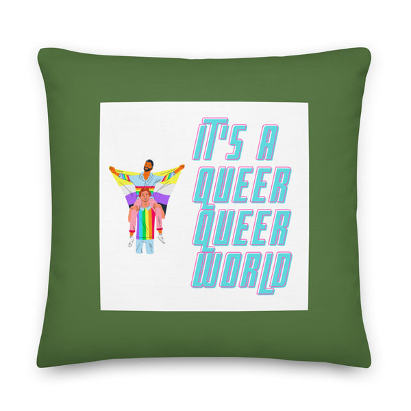 Green square pillow with a white panel reading “It’s a Queer Queer World” and two colorful figures
