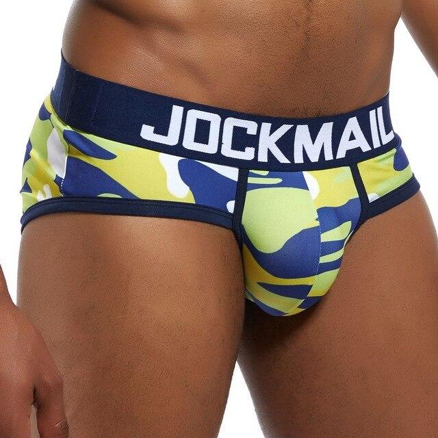 Model wearing blue, lime green, and white camouflage briefs with a Jockmail waistband