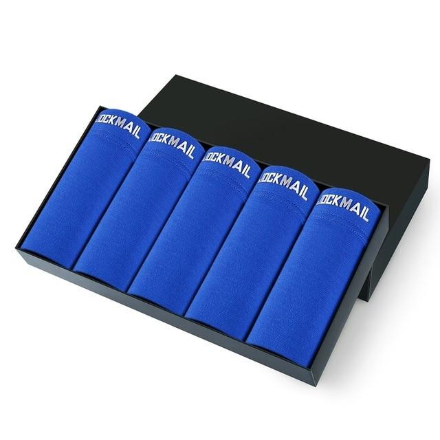 Five royal blue Jockmail boxer briefs arranged in a black presentation box
