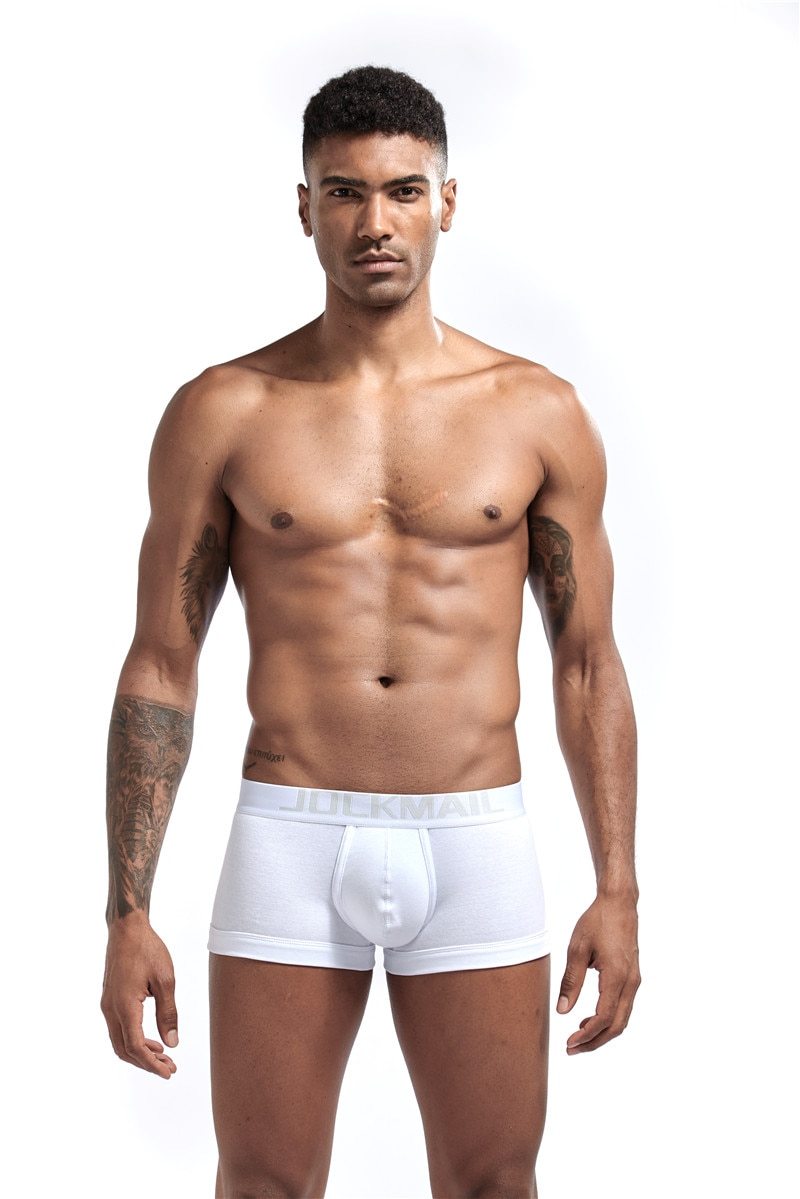 White Jockmail boxer briefs with contoured pouch and branded waistband, worn by a model