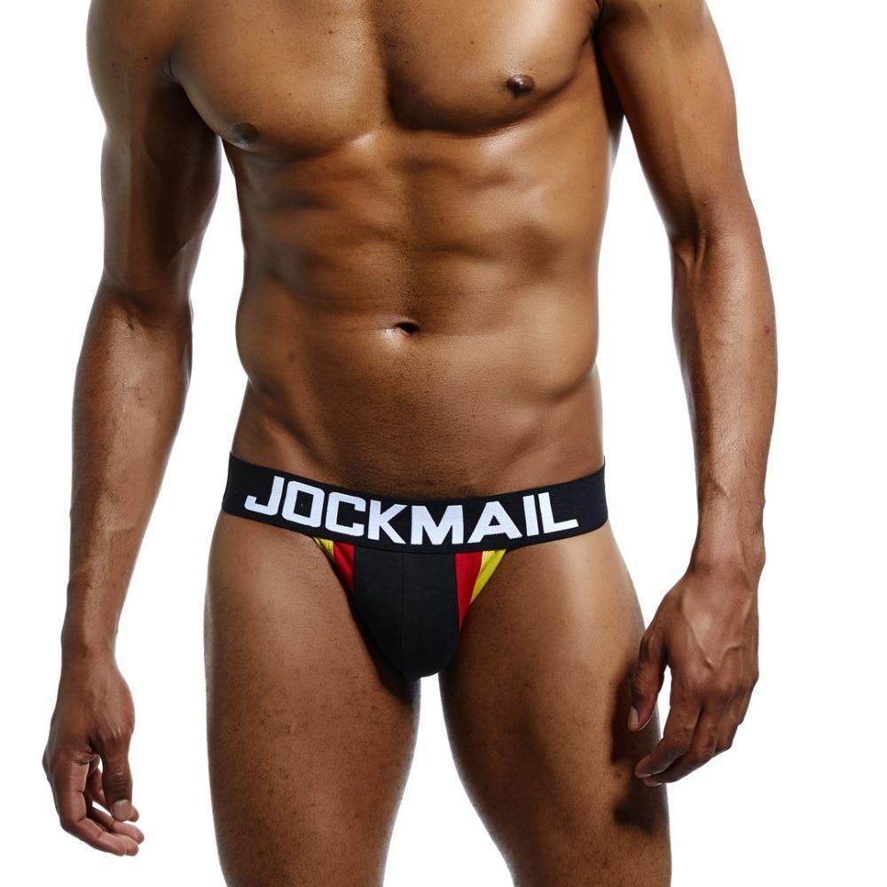 Model wearing a black jockstrap with JOCKMAIL waistband and German tricolour side panels
