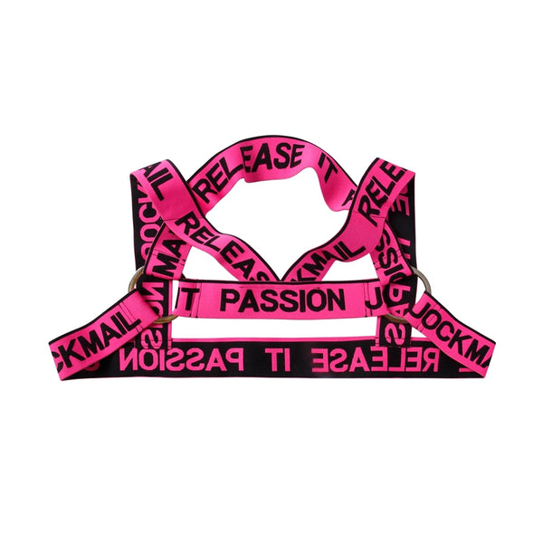 Flat lay of a neon pink elastic harness with black “RELEASE IT” and “PASSION” text