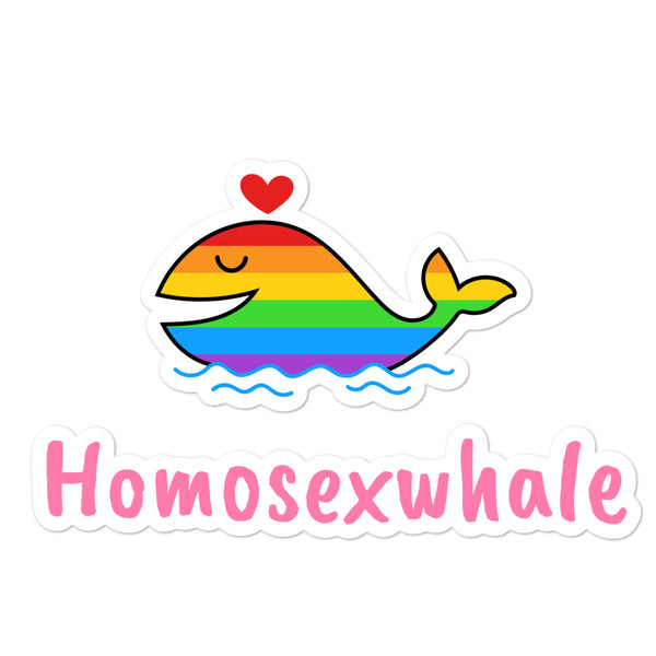 Bubble-free vinyl sticker shows a cartoon whale in rainbow stripes with a heart above, swimming over blue waves; playful queer vibes.