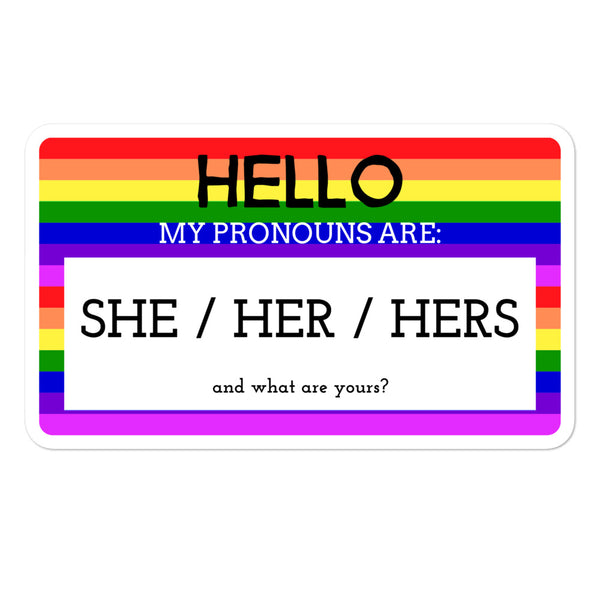 Rainbow-striped sticker reading “HELLO MY PRONOUNS ARE: SHE / HER / HERS”
