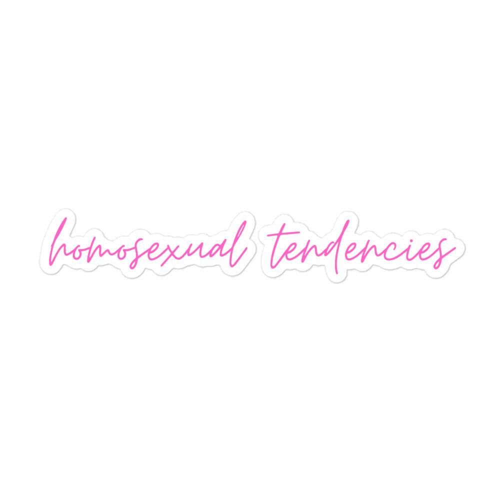 White die-cut sticker with pink script reading “homosexual tendencies”