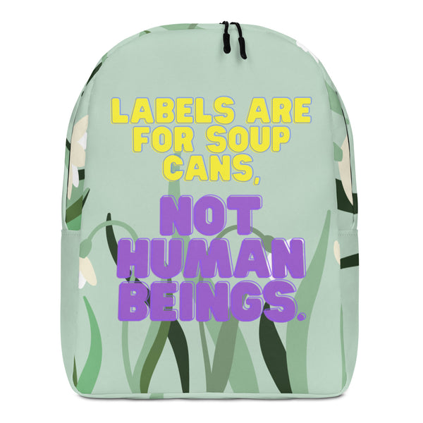 Front-facing mint green backpack reading “Labels are for soup cans, not human beings.”
