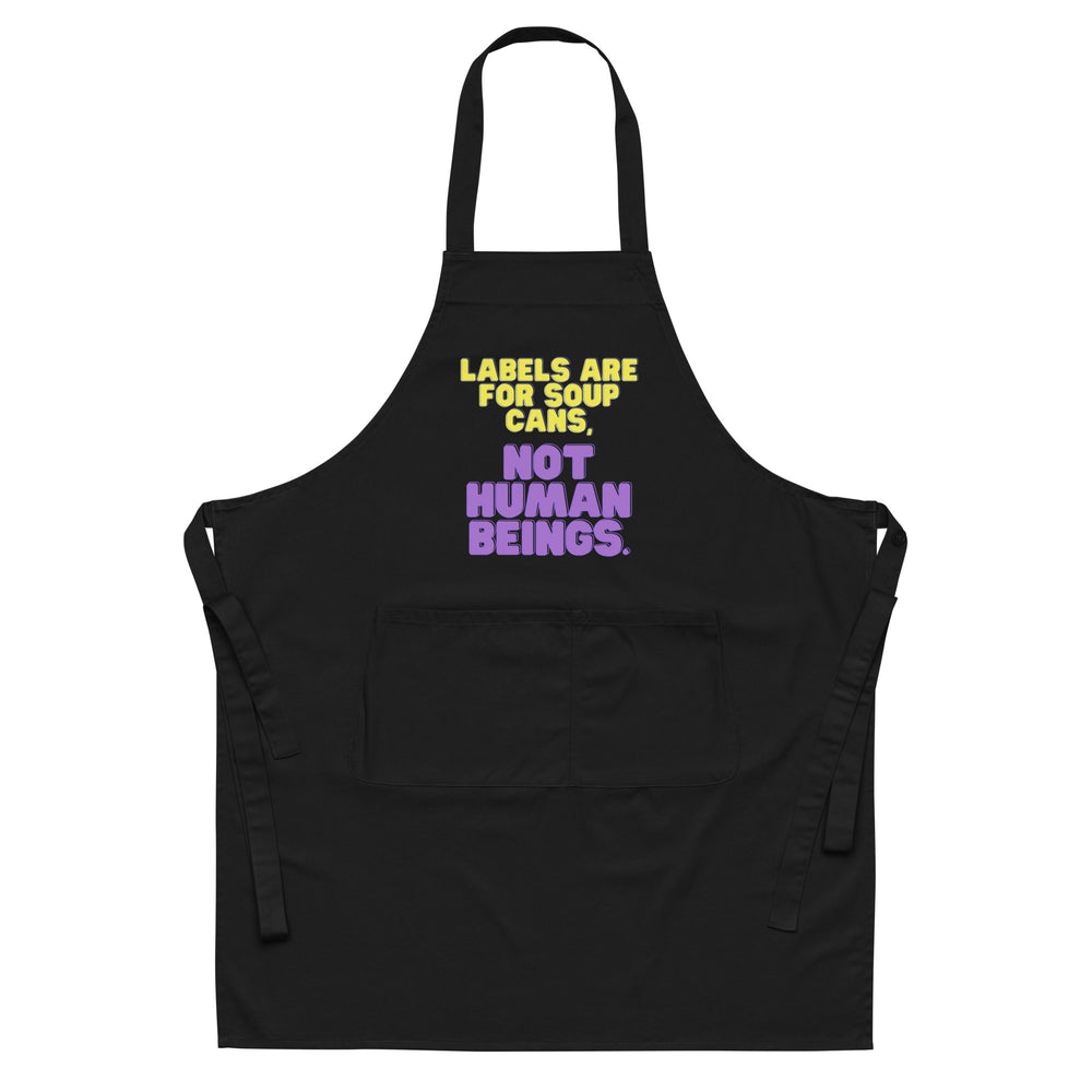 Front view of a black apron reading “LABELS ARE FOR SOUP CANS, NOT HUMAN BEINGS.”