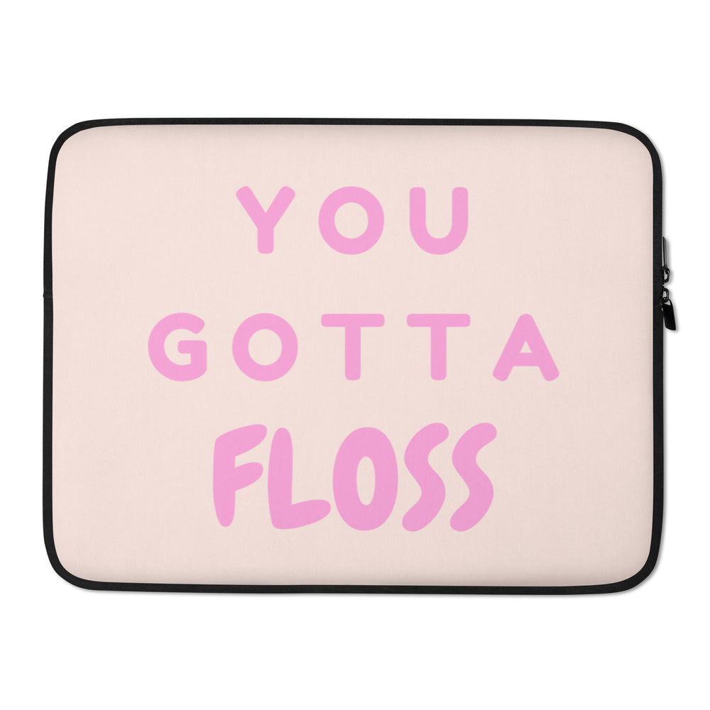 Pale pink laptop sleeve with black trim and zipper, reading “YOU GOTTA FLOSS” in pink lettering