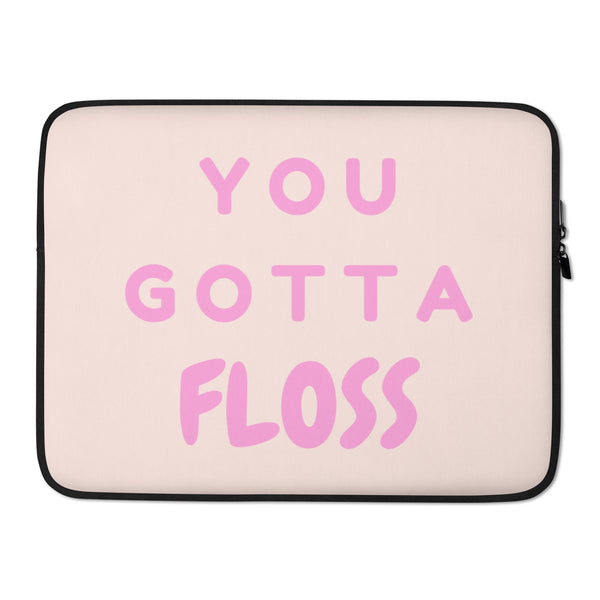Pale pink laptop sleeve with black trim and zipper, reading “YOU GOTTA FLOSS” in pink lettering