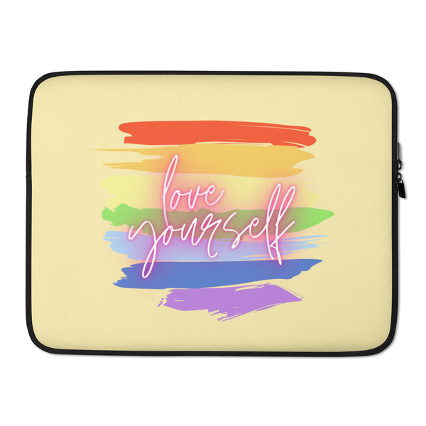Front view of a pale yellow laptop sleeve with rainbow brushstrokes and “love yourself” lettering